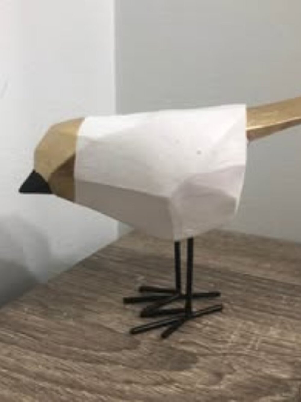 geometric or faceted decorative bird figurine featuring a white body, a black be